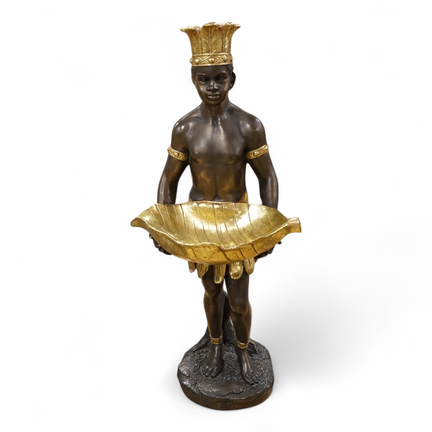 A gilded resin model of an Nubian boy holding a shell and wearing a crown, 65cm high.
